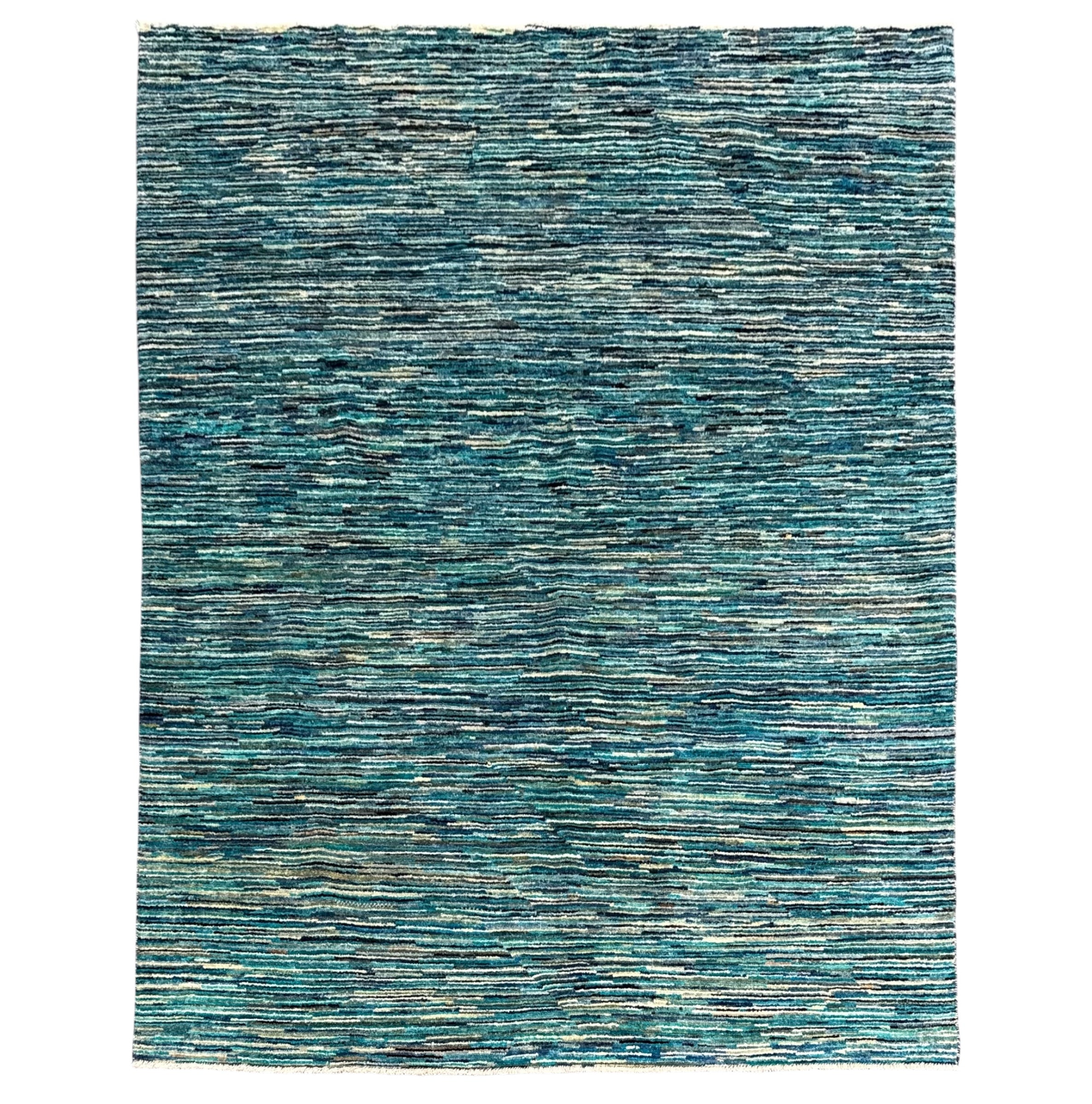 A rectangular area rug with a textured, hand-woven horizontal pattern in shades of teal, blue, and gray, shown flat against a white background.
