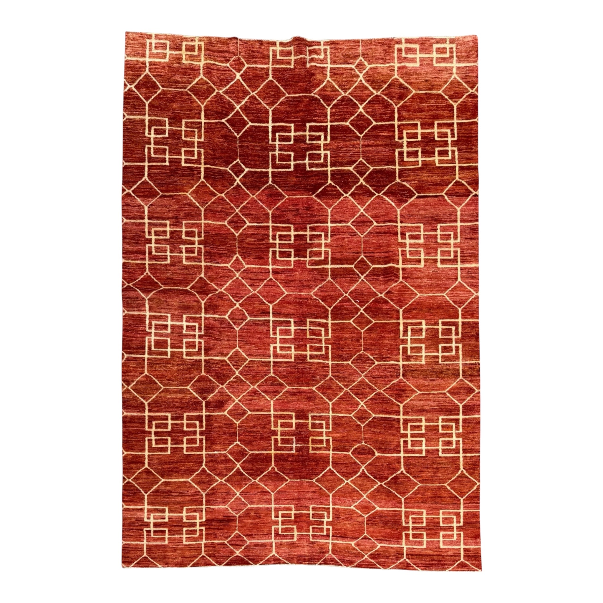 A rectangular area rug with a warm rust-red background and a cream-colored geometric lattice pattern, shown flat against a white background.