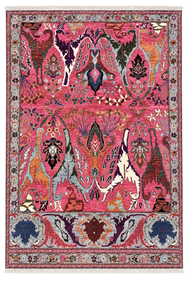 A square area rug with an intricate, symmetrical tribal and floral pattern in vibrant pink, red, blue, green, and beige tones.