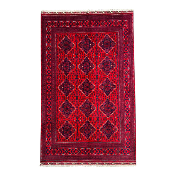 Red patterned rug with geometric design on a white background